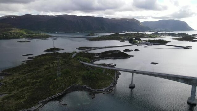 View of the Norwegian Sea and Heroy Bridge with mountains in the background. Norway.