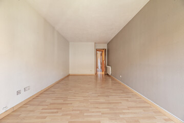 An empty room with a wooden floor, white aluminum