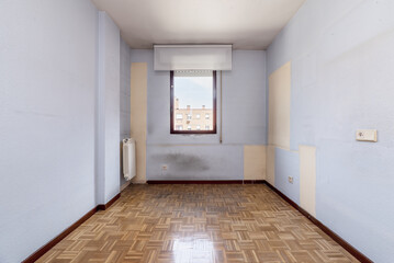 An empty room with a varnished oak parquet floor with a red aluminum