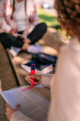 Close up shot of girl underlining important parts of the book