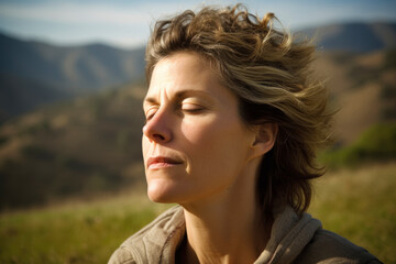 Portrait of a young woman with closed eyes on the background of mountains