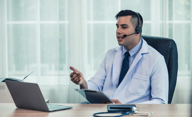 Physician conducts online, distant consultations via video call. Taking medical histories, dealing with patient's concerns, answering queries. Creating a treatment plan and prescribing medications.