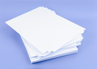 The Stack of blank A4 paper sheets on blue background.