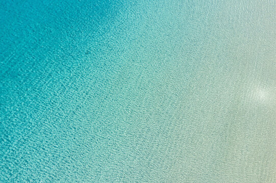 Ocean turquoise blue Aegean sea, aerial drone view. Greece, summer holiday Cyclades island.