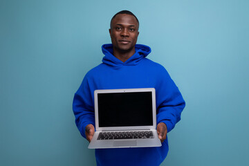 handsome american young consultant showing open laptop on background with copy space