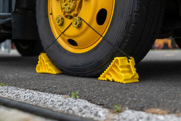 Tire stopper yellow plastic with a rope. 