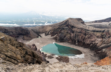 The blue lake in the crater of Gorely volcano. Kamchatka Peninsula, Russia