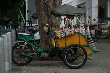 Fototapeta na wymiar Surakarta, Indonesia -05 May 2023; Becak is a traditional means of transportation, tourist transportation which is still active in the city of Solo.