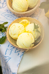 Lemon Ice Cream in bowl. Homemade citrus lemon ice cream with mint close up.