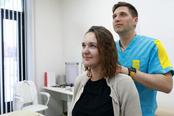 Osteopath relieves muscle pain in neck region of patient