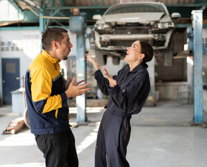 Very happy or surprise Caucasian man and woman mechanic with car lift background at car service	