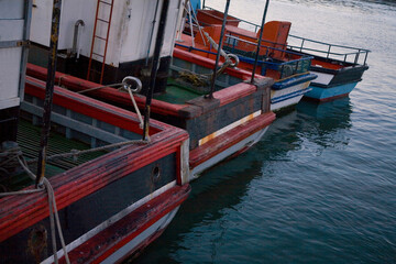 Details of small fishing and crayfishing trawlers moored in Lambert's Bay, harbor, Western Cape, South Africa, in the early evening.