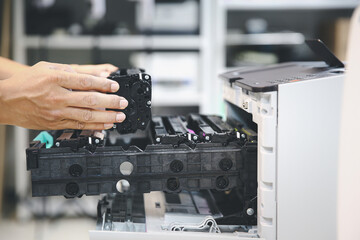 Technician hand open cover printer photocopier or photocopy to replace ink cartridges or fix paper jam for scanning fax or copy document in office workplace.