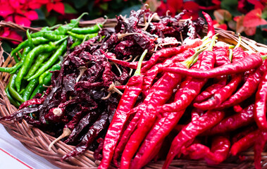 Collection of hot chilies with different varieties arranged on a wicker basket
