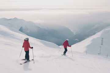Fototapeta na wymiar unrecognizable Young couple skiing on mountain slope