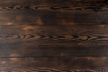 Beautiful wooden background. Burnt wood background. Wooden surface with a burnt pattern.