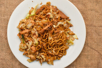 Mie Goreng Jawa or Bakmi Jawa or Java Noodle with spoon and fork. Indonesian traditional street...