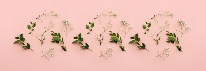 Top view image of flowers composition over pink pastel background