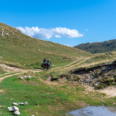 Fototapeta na wymiar Two motorbikers riding off-road on the Trans Euro Trail in Montenegro