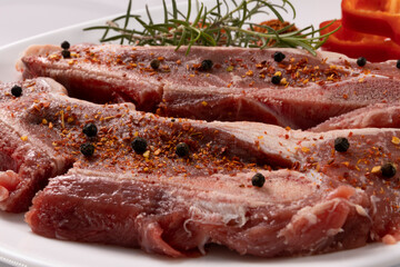 Filetes de ternera con vegetales y especias, sobre fondo blanco