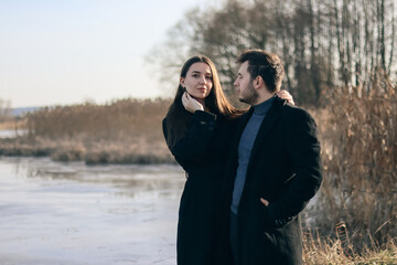 Man and woman in black clothes hugging.Love story.Love between a man and a woman.Photo in nature near the lake.Happy husband and wife.Black clothing style.Romantic photo in nature.love couple.
romance
