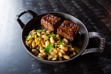 Beans with  filet mingon steaks on the pan