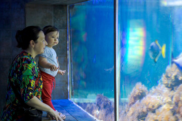 Woman and her daughter in the aquarium
