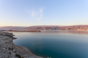 Morning view of arch dam reservoir.
