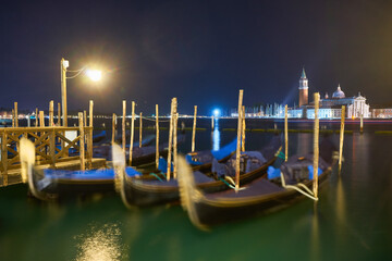 Gondolas at the St. Marks square in Venice, before a dramatic sunrise