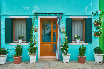 Blue facade of the house with door and windows. Colorful architecture in Burano.