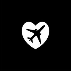 Airplane draws a heart icon isolated on black background 