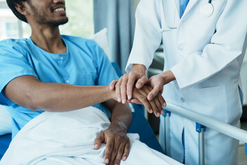 Hand of doctor reassuring his male patient. Medical ethics and trust concept.
