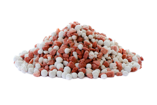 Potassium chloride and superphosphate isolated on white background. Close-up of red and white color mineral fertilizer, top view. Heap of potassium chloride and superphosphate on a white background.