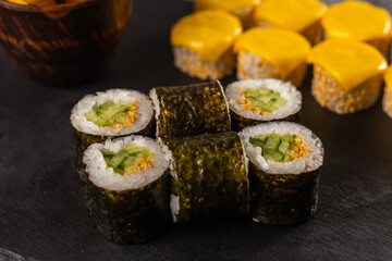 Sushi rolls set on dark background close-up. Japanese and asian food concept