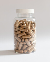 A jar with ashwagandha capsules on a white background, body supplementation, healthy diet