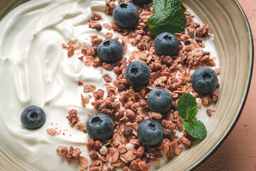 yogurt with chocolate muesli, with berries, blueberries, breakfast, close-up, fork on top, no people,