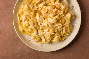 Fettuccine, tagliatelle, in creamy garlic sauce, Italian traditional cuisine, pasta carbonaro,