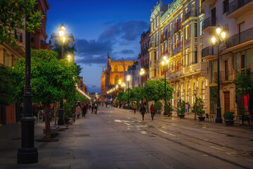 Fototapeta na wymiar Avenida de la Constitucion Street at Night with Seville Cathedral - Seville, Andalusia, Spain
