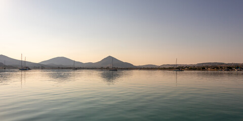 Fototapeta premium Panoramic view of yachts at anchor in the bay of Kolladia, Greece at sunset