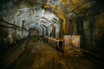 Old abandoned mine with rusty trolley train