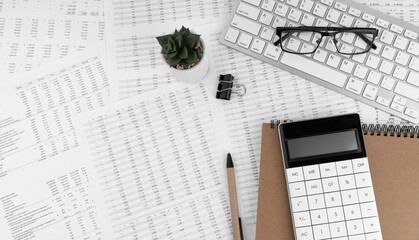 Calculator, keyboard, magnifying glass, pen, eye glasses lying on financial documents . Financial and business concept. Top view.