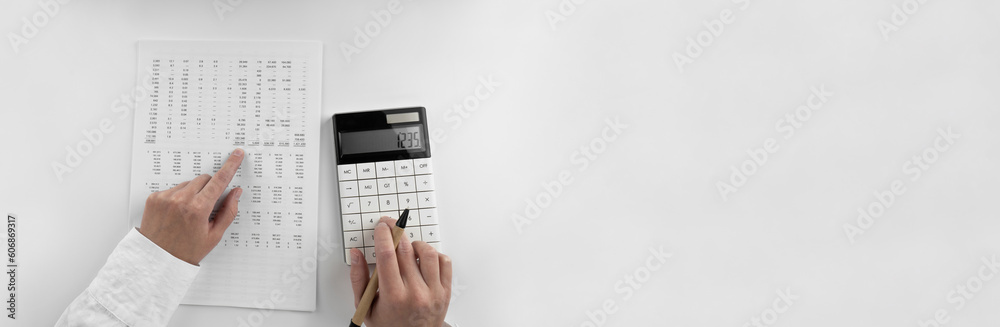 Canvas Prints woman using a calculator and points her finger at the numbers in the financial documents. financial,