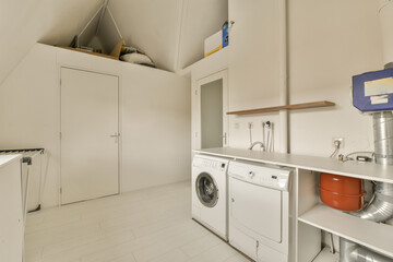 a laundry room with a washer, dryer and washing machine in the corner on the right hand side