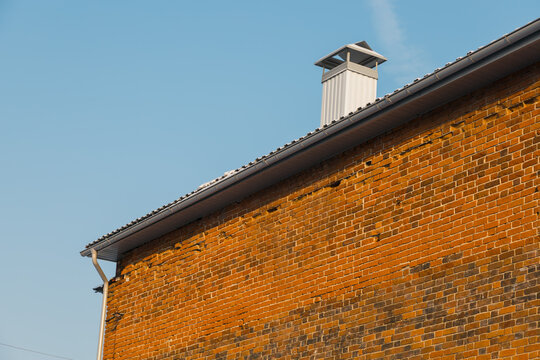 Close up chimney on roof and sky, brick wall of house