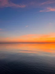 Foto op Canvas Orange sky after the sunset at the sea, evening sea horizon  © Oksana