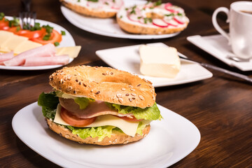 breakfast with bagels and coffee on wooden table