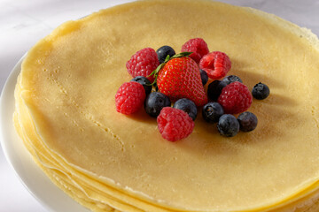 Stack of crêpes with fresh berry fruits
