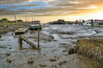 View of the town (commune) of Gujan-Mestras at low tide of the Atlantic Ocean in the Arcachon Bay in the early morning. Ocean water receded from the bay at low tide. Gironde department, region Nouvell