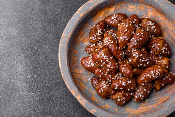 Chicken hearts fried in soy sauce with salt and spices in a plate