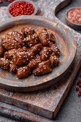 Chicken hearts fried in soy sauce with salt and spices in a plate